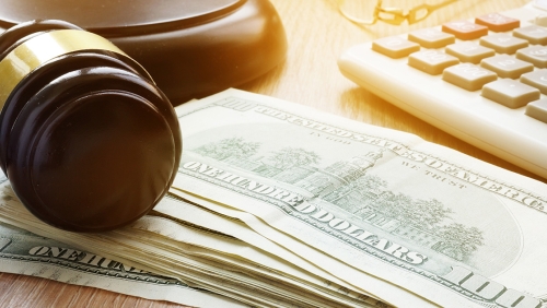 Gavel placed atop stack of US dollars