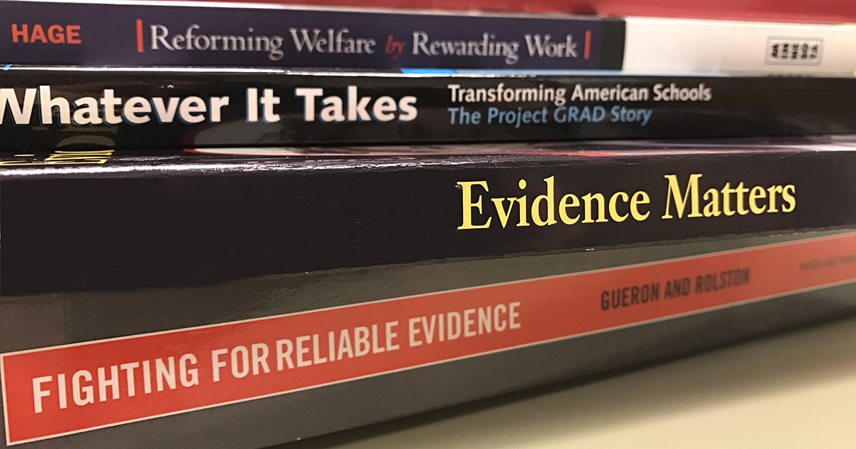 Close-up of books about Evidence, Education, and Welfare