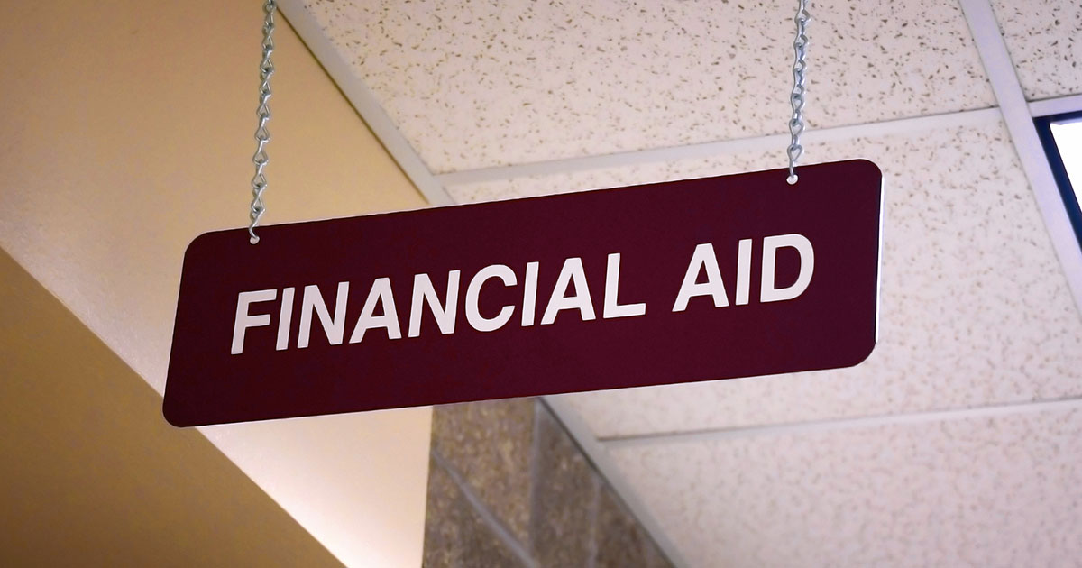 Sign that reads 'Financial Aid' hanging in a school building