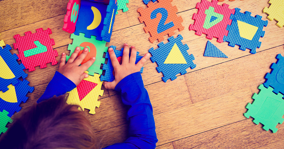 Child playing with letters and shapes