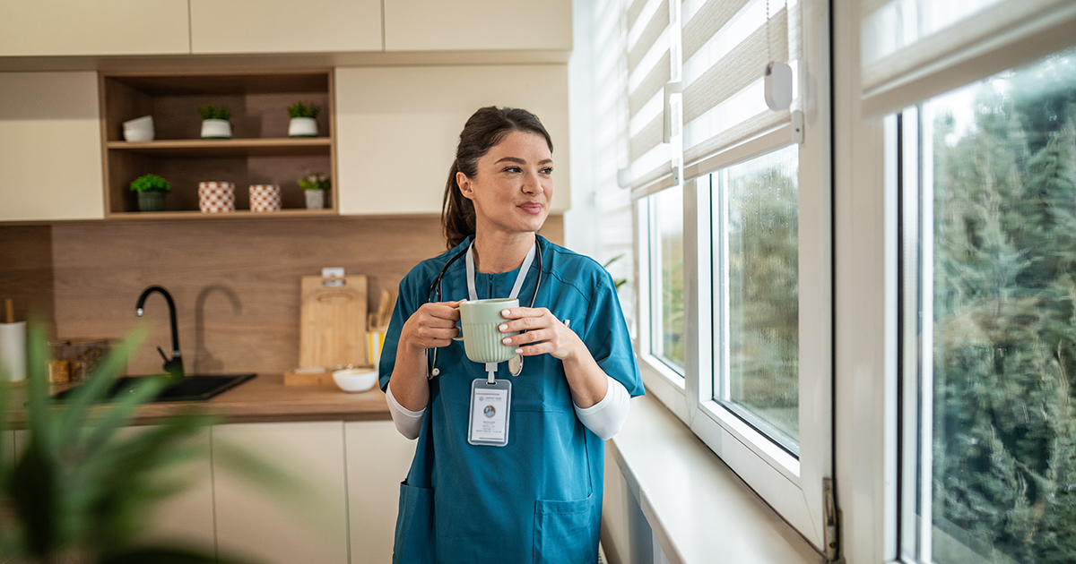 a nurse student is standing with a coffee cup