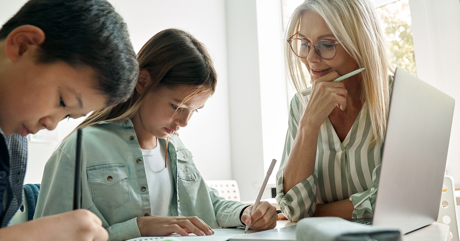 A proctor oversees the tutoring session of a boy and girl in middle school