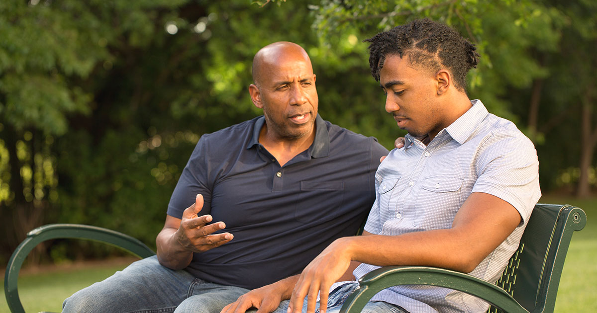 an older mentor is talking to a young guy