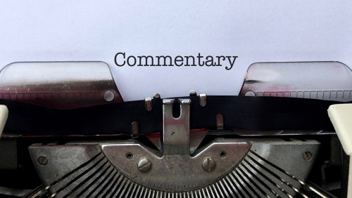 Paper in typewriter that reads Commentary