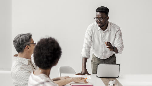 Black man gives presentation to colleagues