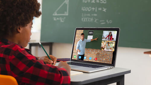 A Black high school student participates in an online tutoring session