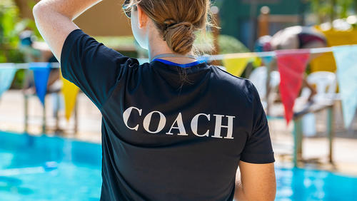 young girl a sweaming coach on a pool