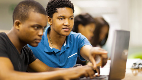 Young Black men work together on a computer